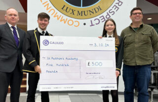 Two School students hold an oversize gift cheque